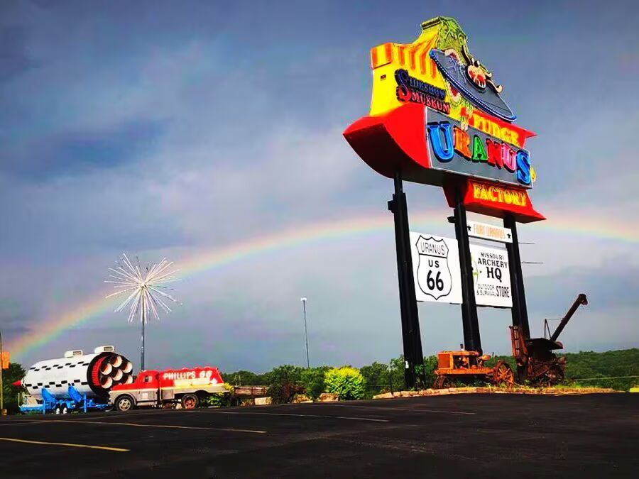Sign for Uranus Fudge Factory and General Store with ice cream graphic.
