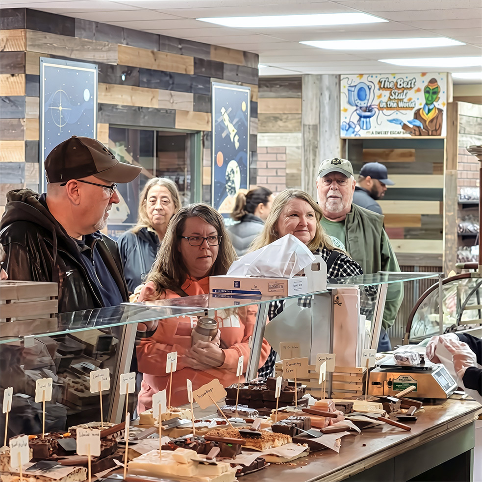 Customers watching fudge being made at the fudge counter inside Uranus Fudge Factory in Anderson, Indiana
