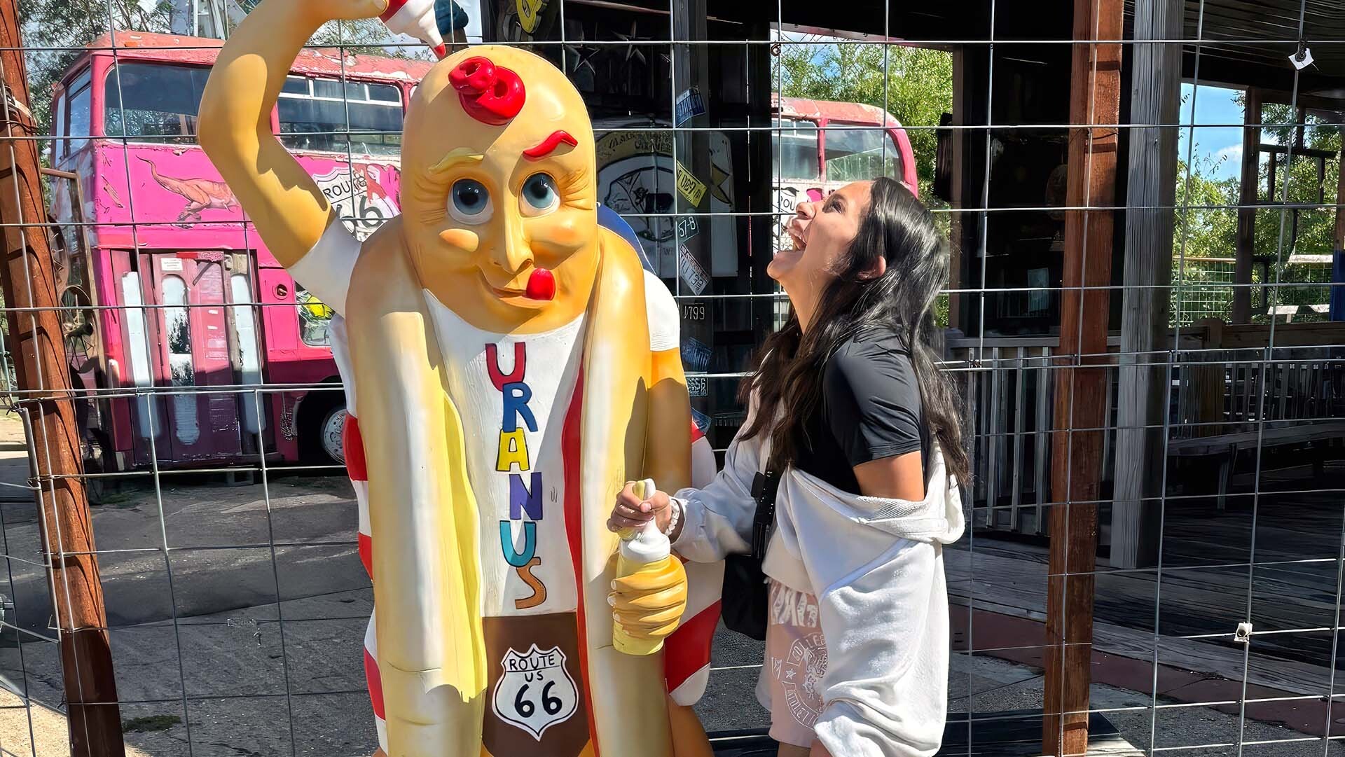 Visitor laughing with a hot dog at the Big Wieners stand at Uranus in St. Robert, Missouri