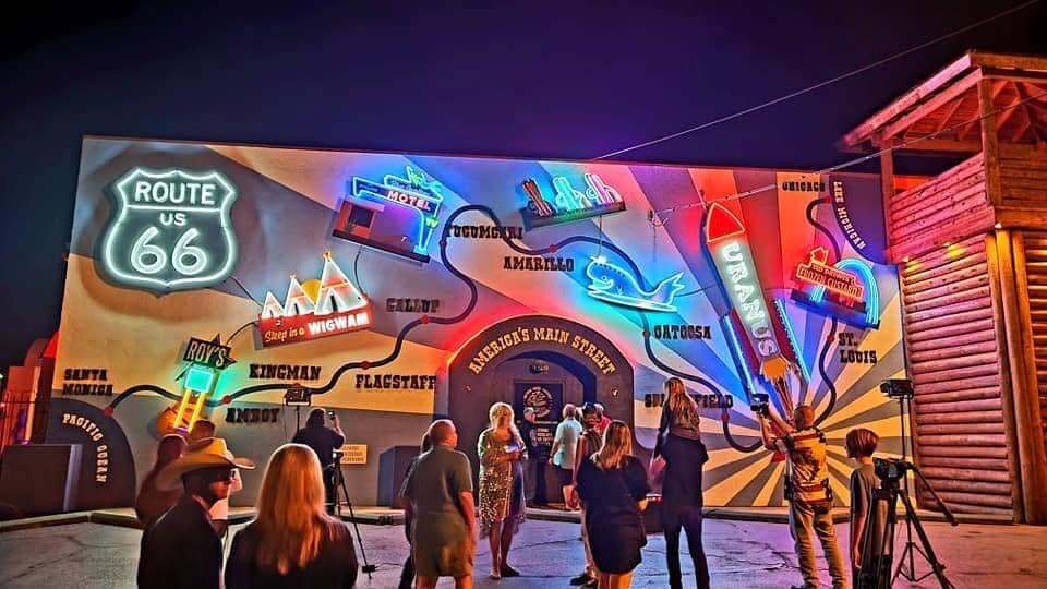 Glowing neon mural of the Route 66 map at night in Uranus Missouri showing stops including Tucumcari, Amarillo, Catoosa, St. Louis and Uranus