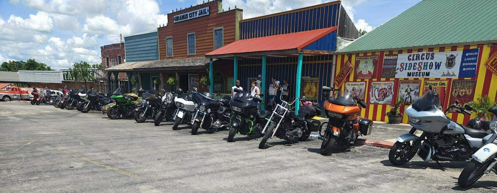 Row of touring motorcycles parked outside the Circus Sideshow Museum and Uranus City Jail buildings in Uranus Missouri