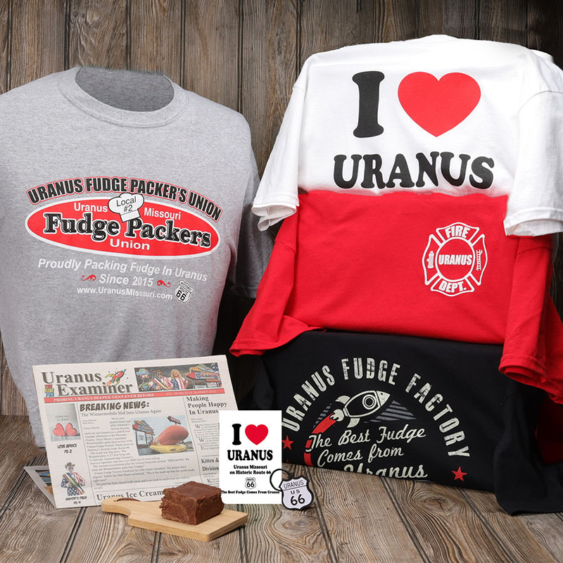 An Explore Uranus Bundle from Uranus Fudge Factory with a shirt, keychain, and a quarter pound of fudge